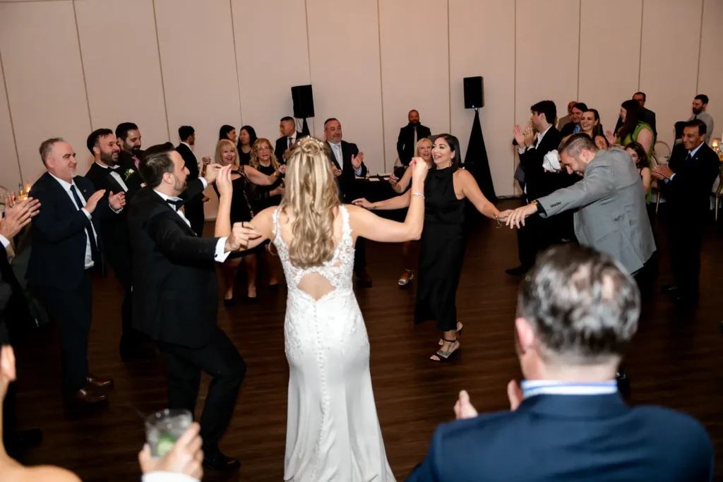 a wedding dance floor fills with people doing a traditional turkish dance. Shot at Carmen's Event Centre, Hamilton by Pixelesque Photography.
