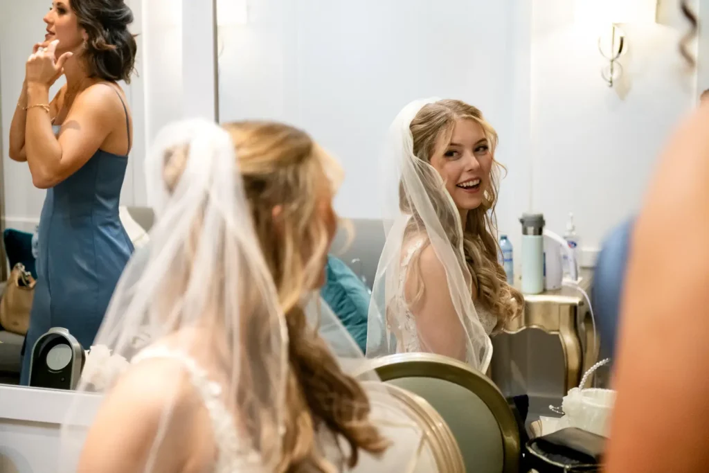 the bride checks out her veil in the mirror. Shot at Carmen's event centre, Hamilton by Pixelesque Photography.