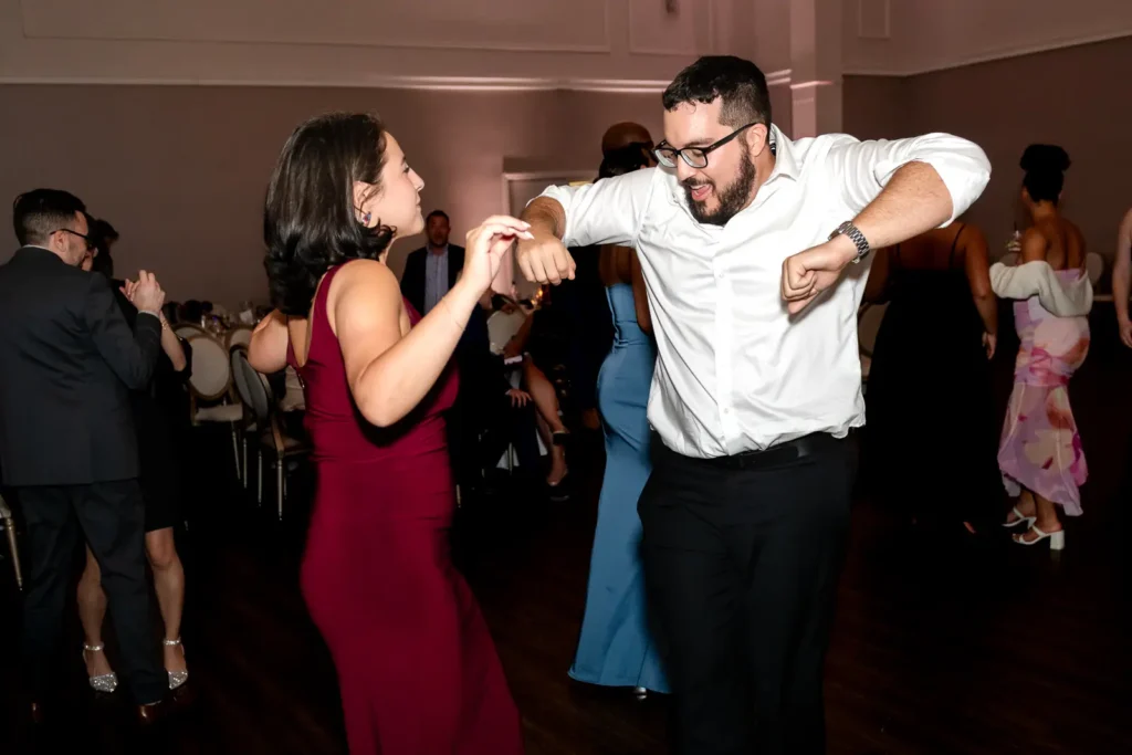 A wedding guest dances. . Shot at Carmen's Event Centre, Hamilton by Pixelesque Photography.