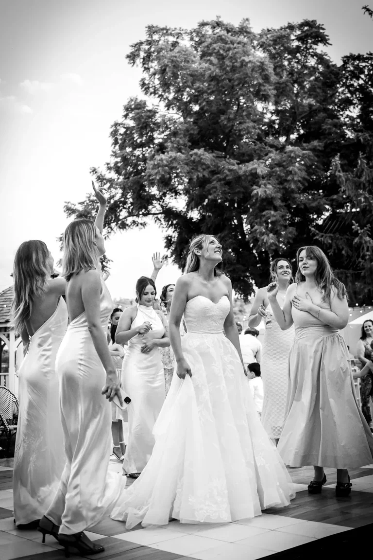 Groom performing with his band from the balcony overlooking the dance floor as the bride dances.