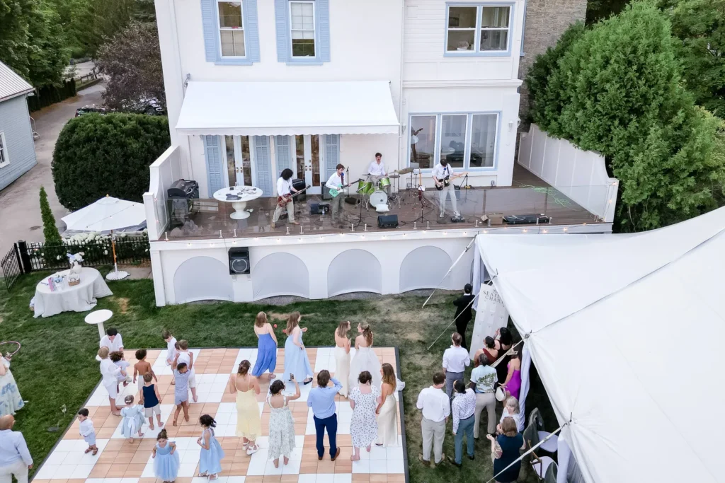 Groom performing with his band from the balcony overlooking the dance floor.