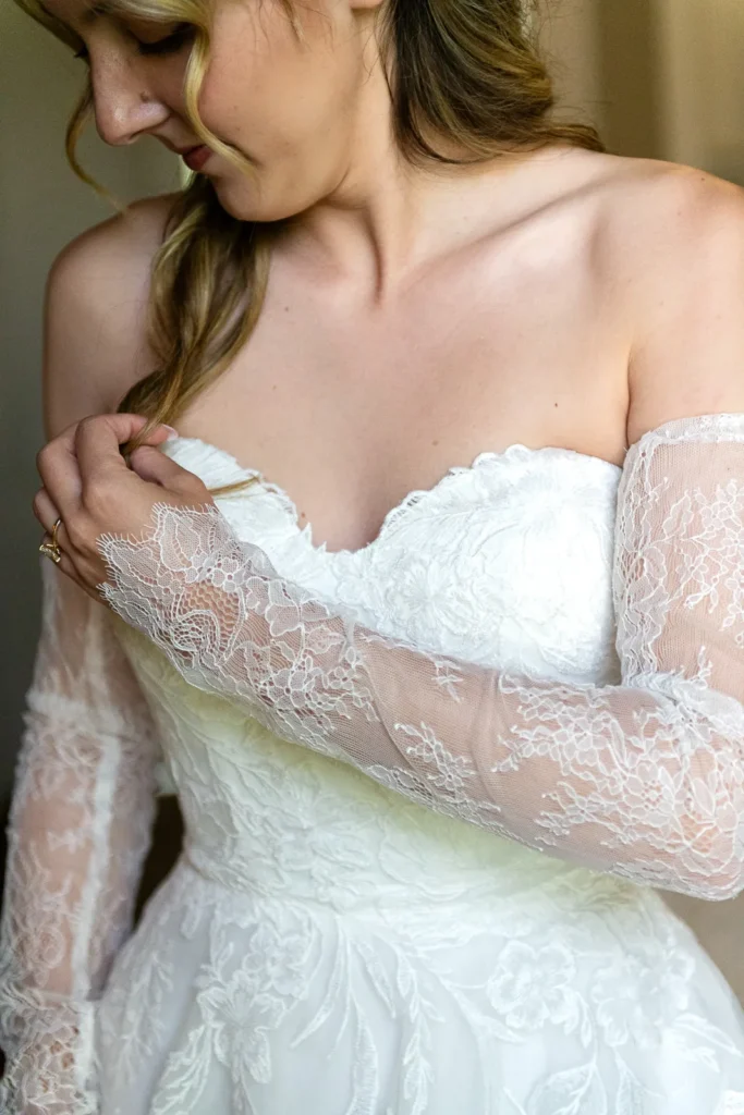 Bride adjusts her long lacy gloves before the ceremony.