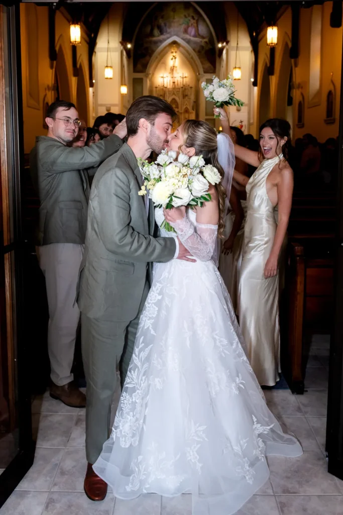 Bride and groom share a kiss outside St. Gregory’s Church.