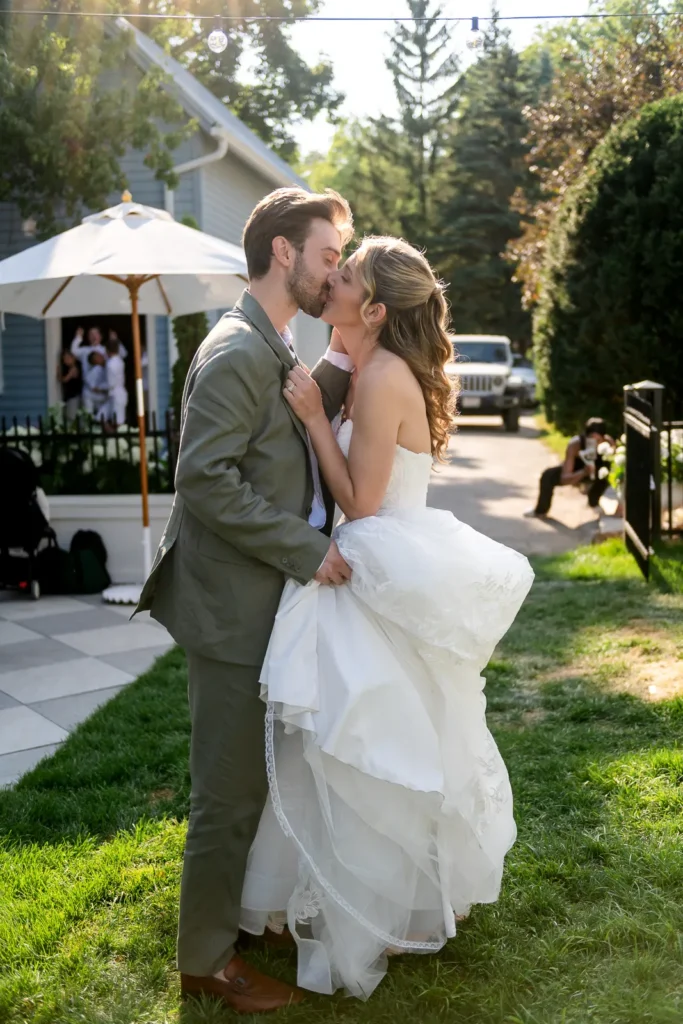 The wedding couple enters the cocktail hour with a hug and kiss