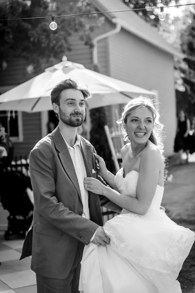 The wedding couple enters the cocktail hour with a hug and kiss