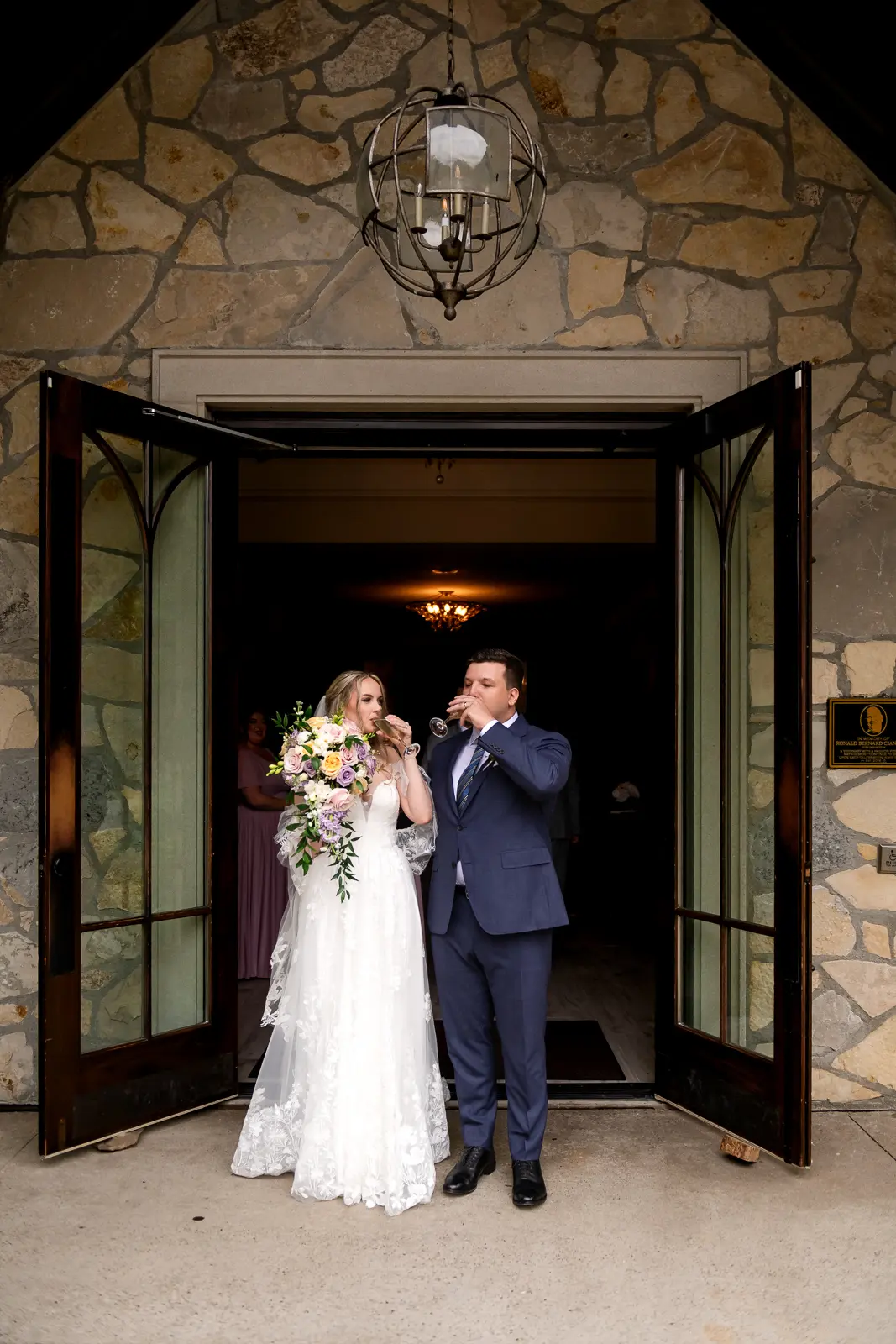 newlywed bride and groom have a champagne toast at Ancaster Mill in Hamilton, Ontario.