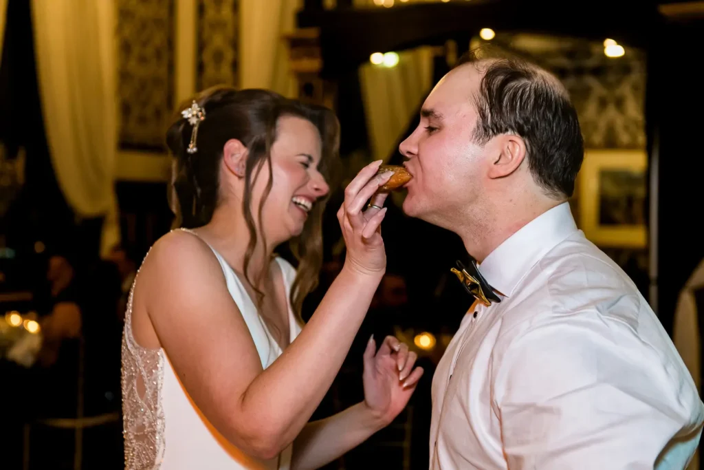 bride feeds groom a wedding donut at ingersoll wedding