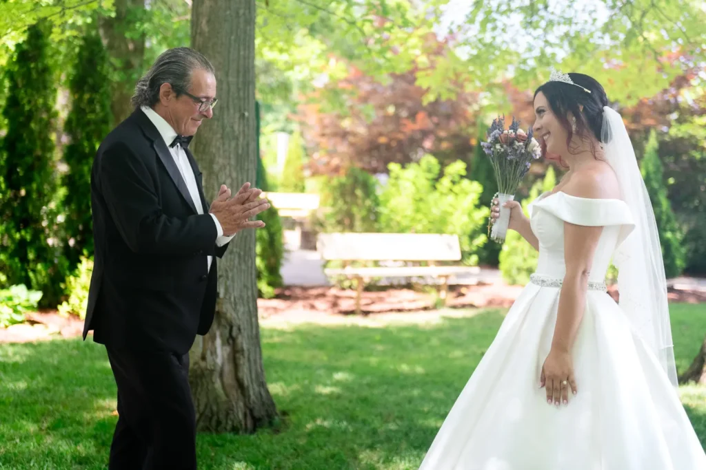 a father looks back at his daughter in shock during their first look at Club Roma in St. Catharines Niagara.