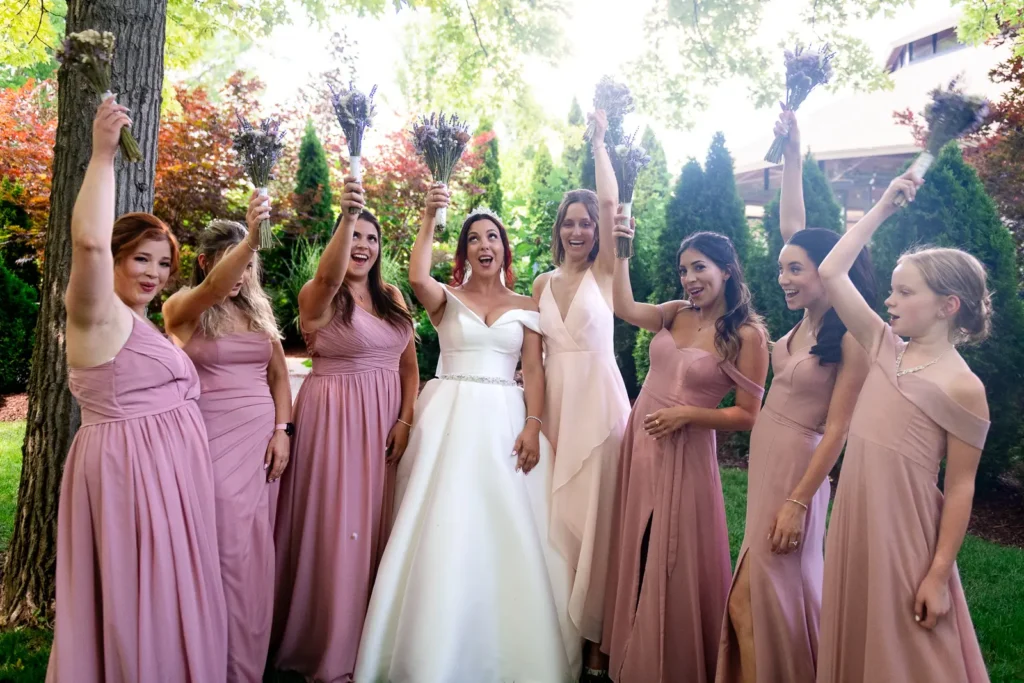 a bride and her bridesmaids cheer with their flowers at Club Roma in St. Catharines Niagara.