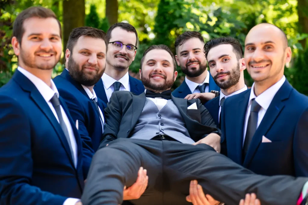 groomsmen hold the groom up at Club Roma in St. Catharines Niagara.