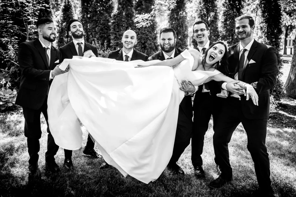 groomsmen hold the bride up at Club Roma in St. Catharines Niagara.