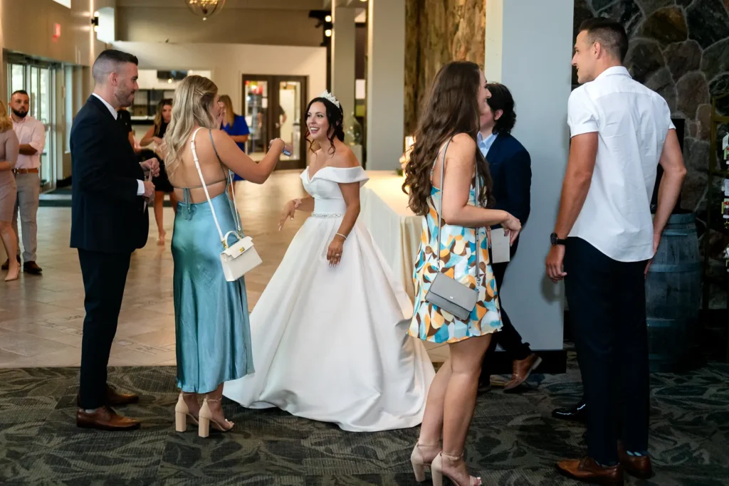 the bride mingles with people during cocktail hour at Club Roma in St. Catharines Niagara.