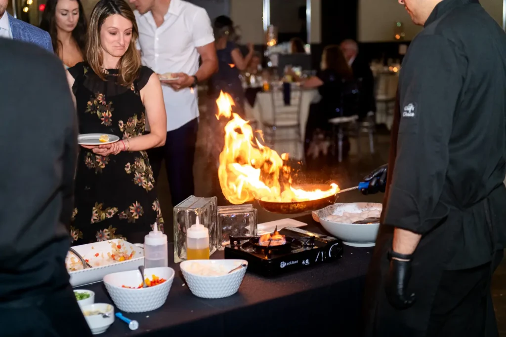 flames leap off the pan at the live cooking station during cocktail hour at Club Roma in St. Catharines Niagara.