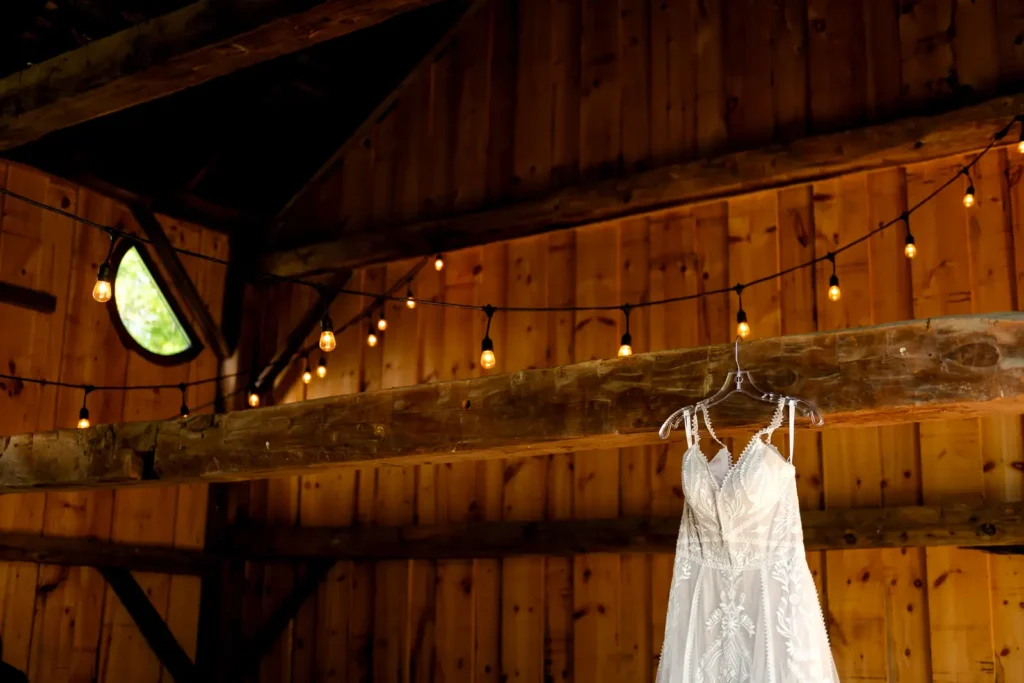 a wedding dress hangs from a barn beam at Homegrown Hideaway in Norfolk County, Ontario.