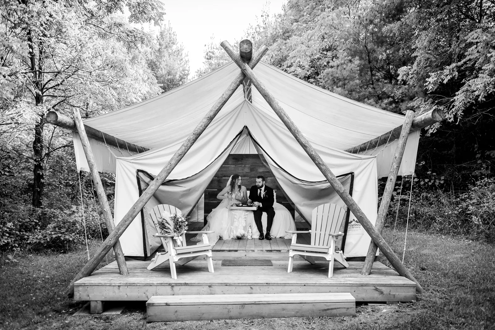 a bride and groom have a quiet moment and a snack in a glamping tent at Homegrown Hideaway in Norfolk County, Ontario.