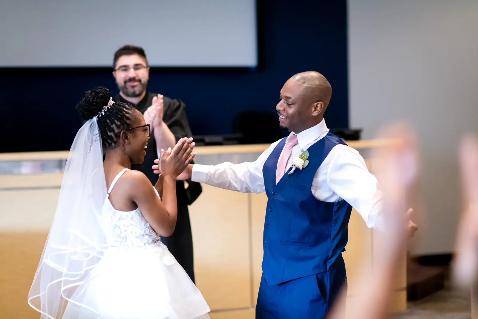 a couple celebrate getting married at their elopement in Thorold City Hall