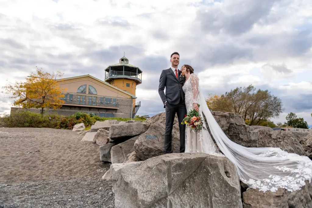 a wedding couple share a moment on the rocks at The Lakeview by Carmen's in Hamilton.