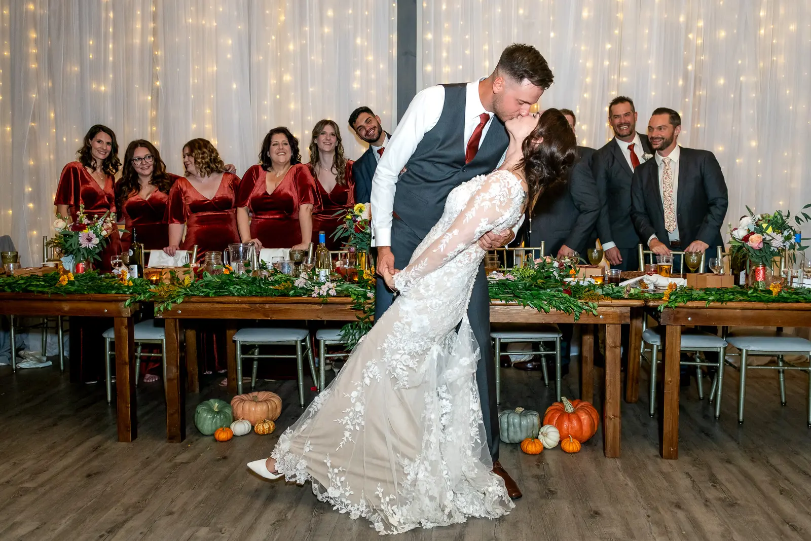 the bride and groom kiss in front of the head table at The Lakeview by Carmen's in Hamilton.