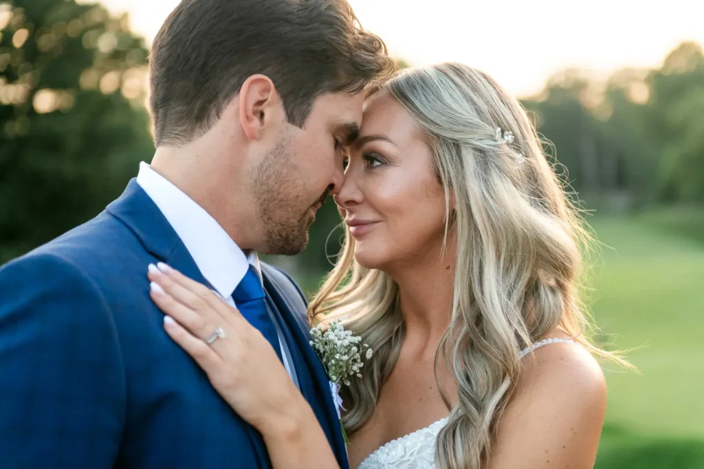 the bride and groom look at each other with dundas valley golf and curling club in the background