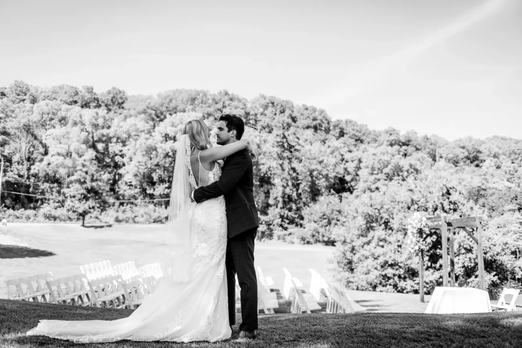 the couple embrace after their first look overlooking the valley at dundas valley golf and curling club