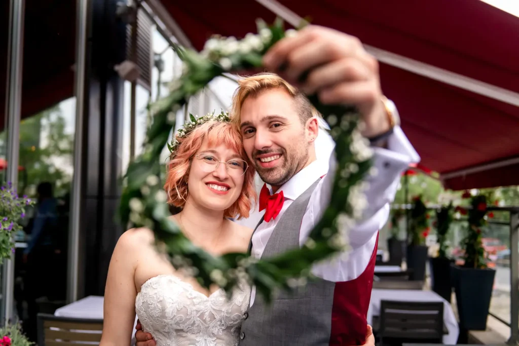 the couple seen through a wreath held by the groom at il ponte cucina italiana in downtown toronto.