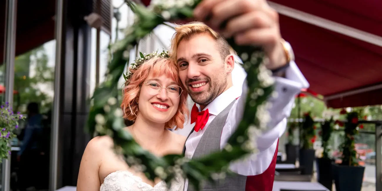 the couple seen through a wreath held by the groom at il ponte cucina italiana in downtown toronto.
