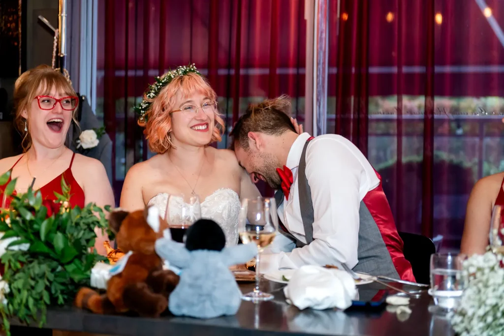 the groom laughs and puts his head on his wife's shoulder during speeches at il ponte cucina italiana in downtown toronto.
