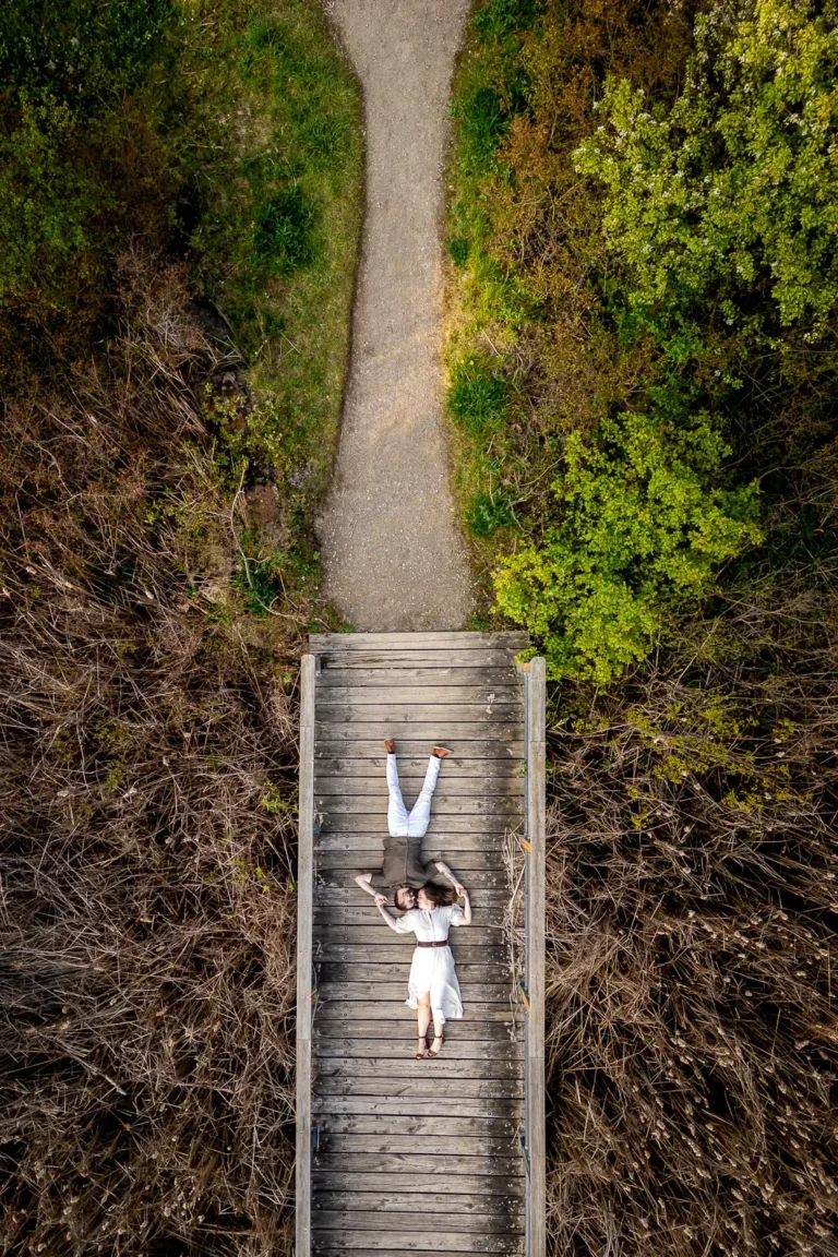 Aerial engagement portrait at Kerncliff Park quarry boardwalk during golden hour
